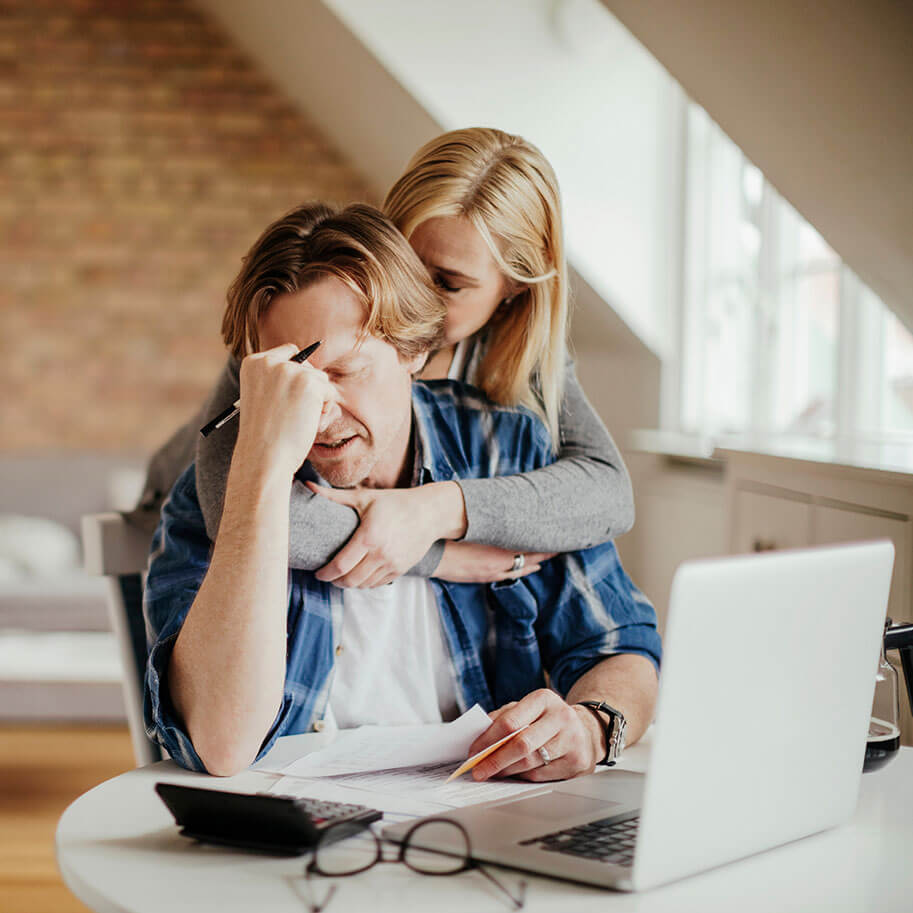A couple feeling stress at a table with papers and a computer. The Ohio wrongful termination age discrimination lawyers at Horenstein, Nicholson & Blumenthal can help you identify when your job dismissal broke the law.