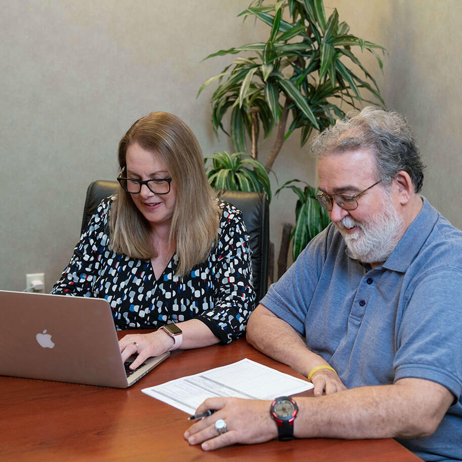 Intake Specialist Jaci Hollmeyer meets with law firm client Jeffrey Thompson at the offices of HNB. The attorneys at HNB give personal attention to your application for disability benefits.