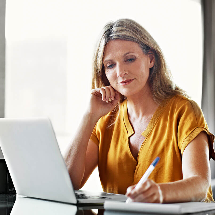 A woman sits at a laptop at a desk. The Ohio wrongful termination gender discrimination lawyers at Horenstein, Nicholson & Blumenthal can guide you through your legal claim.