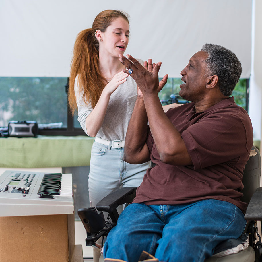 A man in a wheelchair works with a music therapist. Horenstein, Nicholson & Blumenthal lawyers can help you meet the compensation requirements for total disability individual unemployability.