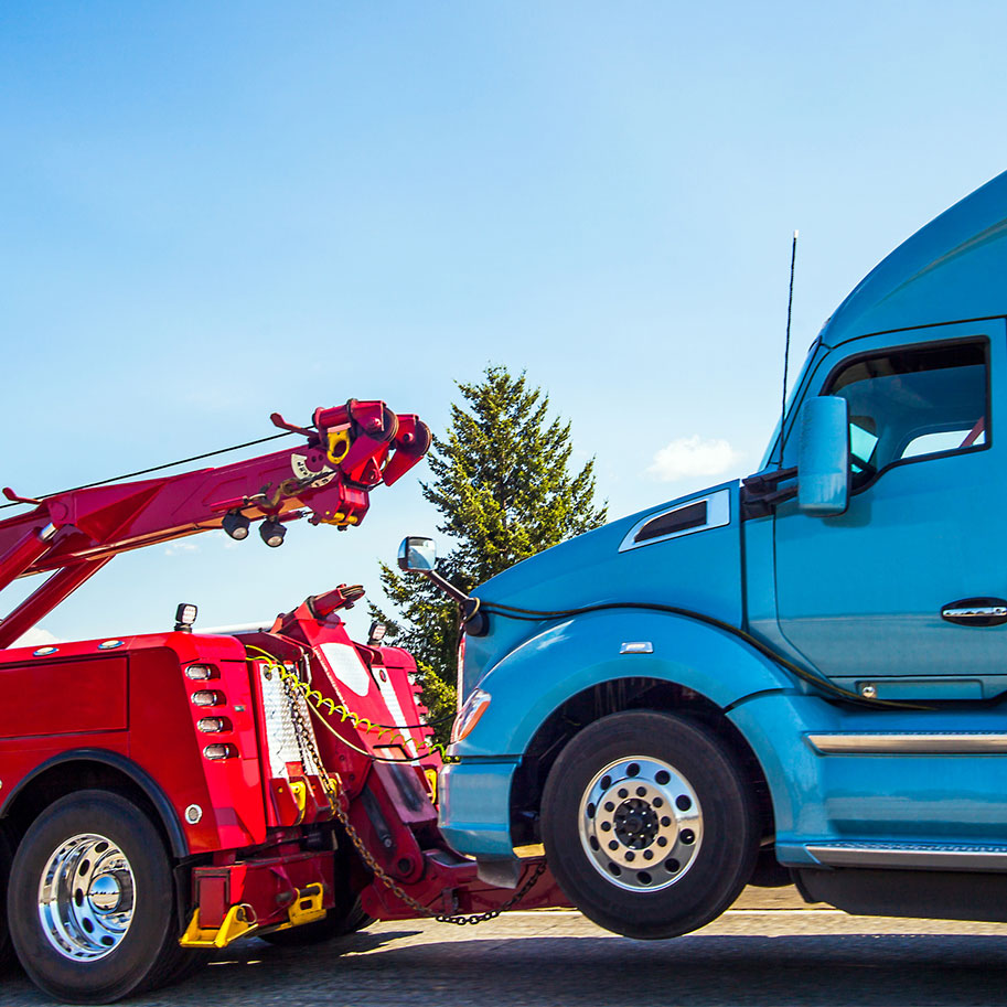 A tow truck hooks up to a tractor-trailer. Get a Horenstein, Nicholson & Blumenthal attorney to investigate your truck accident causes and show how the driver was negligent.