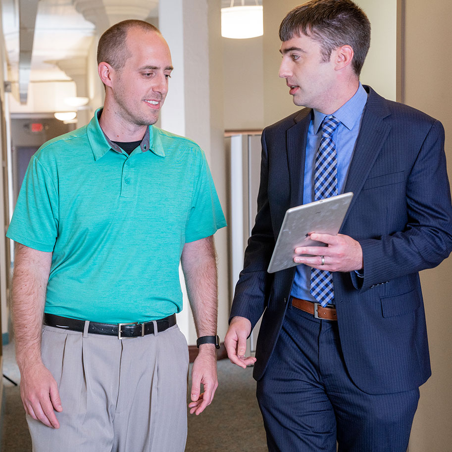 HNB visitor Jacob Loeffelholz, left, talks with attorney Rob Walter in the HNB offices. You can get help for many health and financial hardships from the attorneys at HNB.