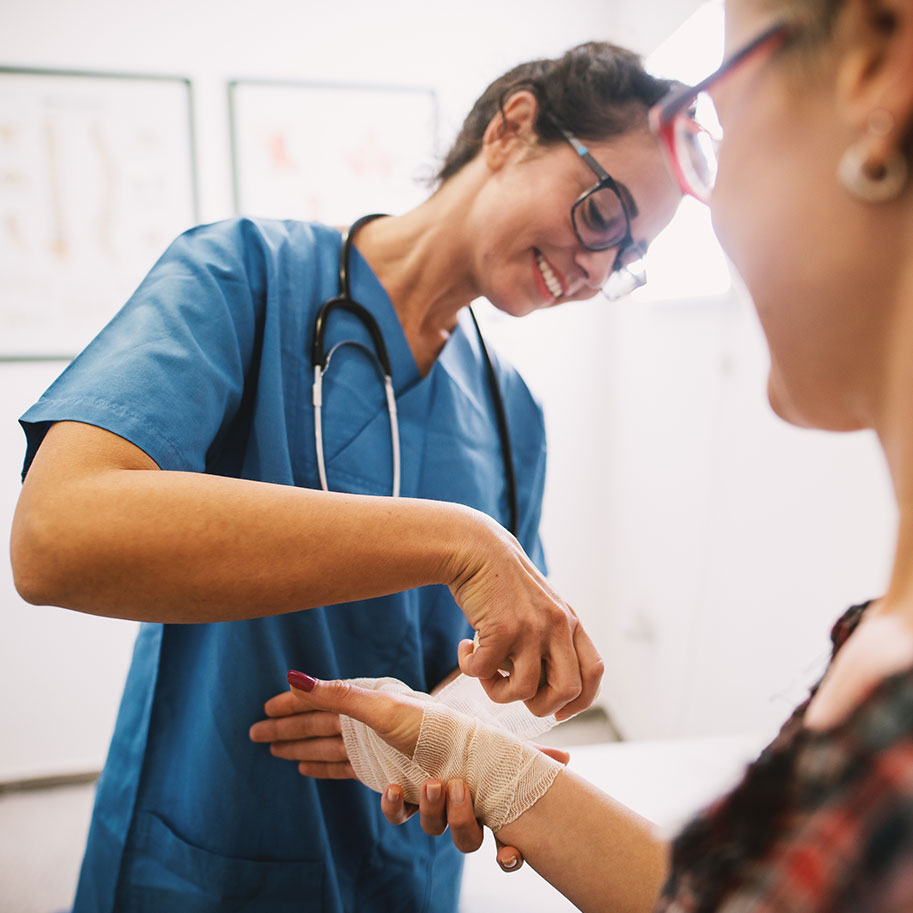 A doctor wraps a bandage on a woman’s wrist. Workers’ compensation for joint injuries covers many types of trauma that you can suffer on the job.