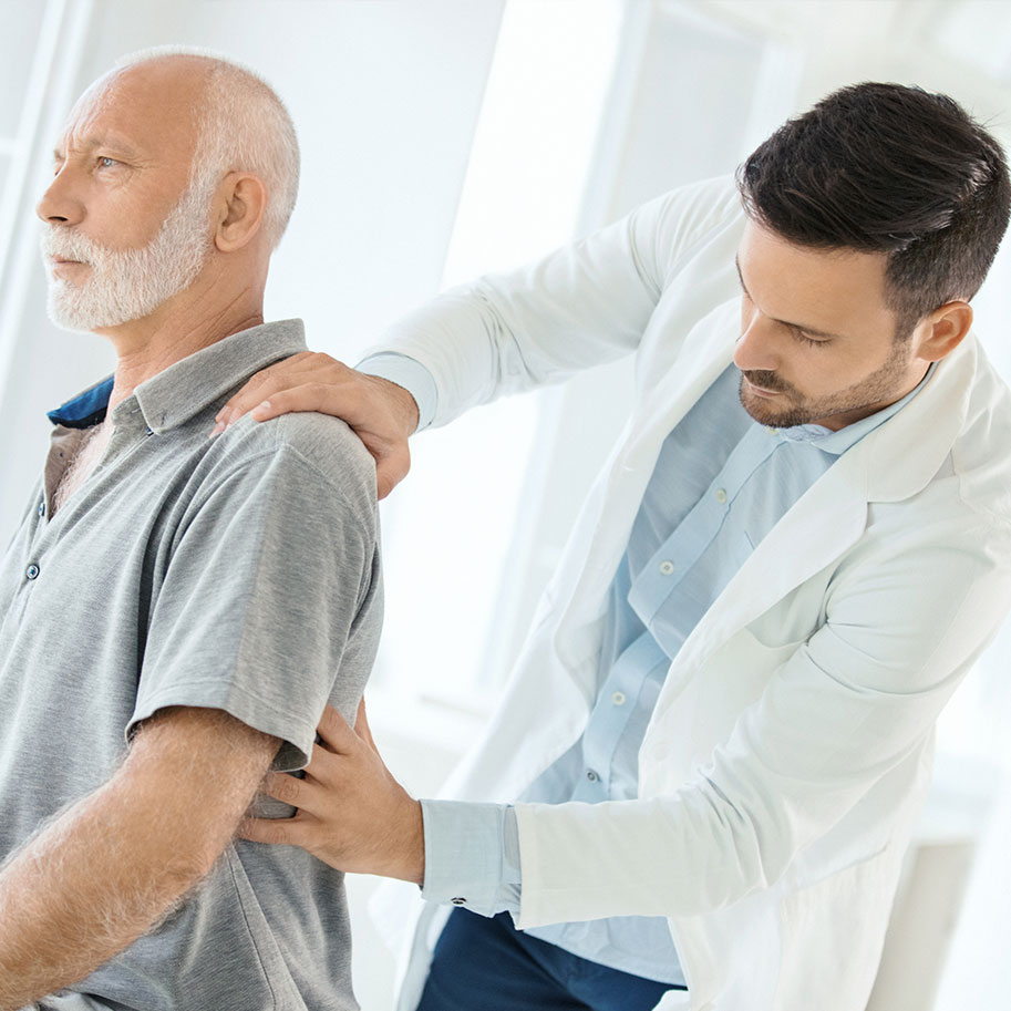 A doctor examines a man’s back. An HNB lawyer can help you document your neck or back pain symptoms and prove to Social Security that you should receive disability benefits.