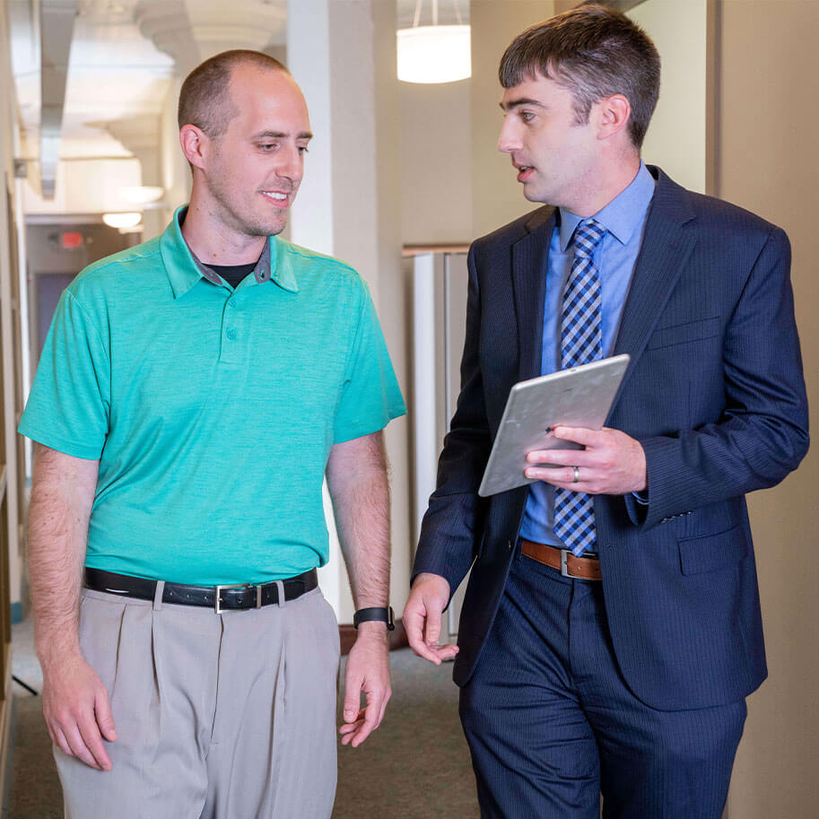 Attorney Robert Walter walks down the hall with HNB law firm visitor Jacob Loeffelholz.