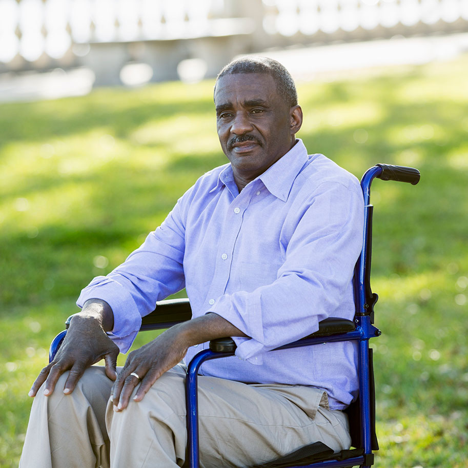 A man sits in a wheelchair in a park. HNB’s SSI lawyers can help you meet the qualifications for disability benefits.