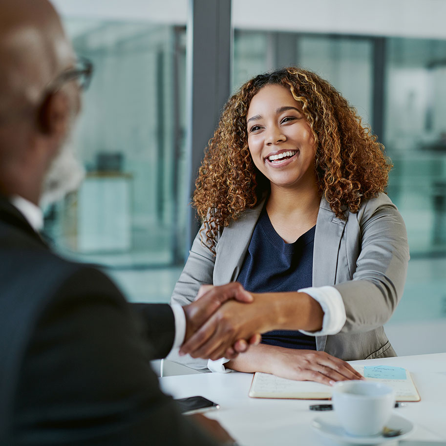 A woman shakes hands with a man across an office table. After you’re hurt in an accident, get what’s fair from the insurance company with help from Horenstein, Nicholson & Blumenthal.