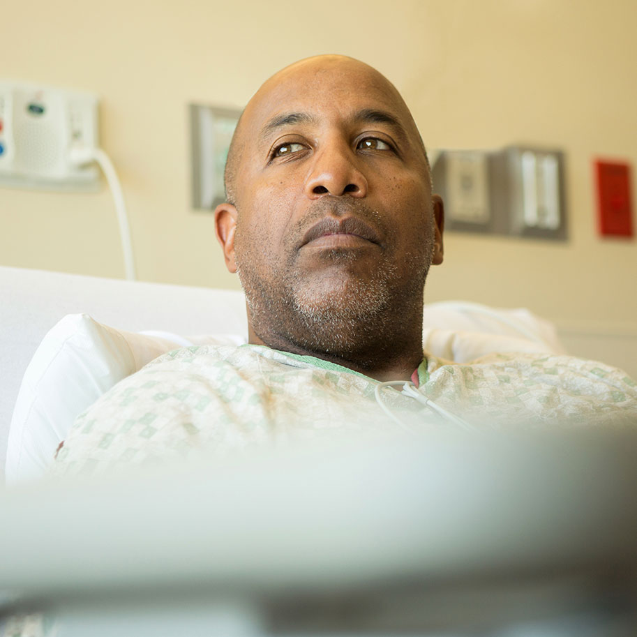 A man in a hospital bed looks toward a window. HNB lawyers can help you gather the medical evidence that proves you need disability benefits for cardiovascular disease.