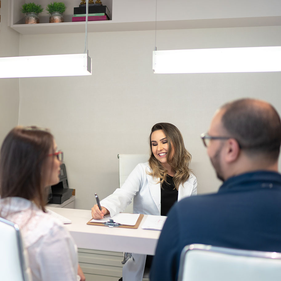A couple sits at a desk across from a doctor. The manufacturing employees’ workers’ compensation lawyers at Horenstein, Nicholson & Blumenthal fight for every benefit due to you.