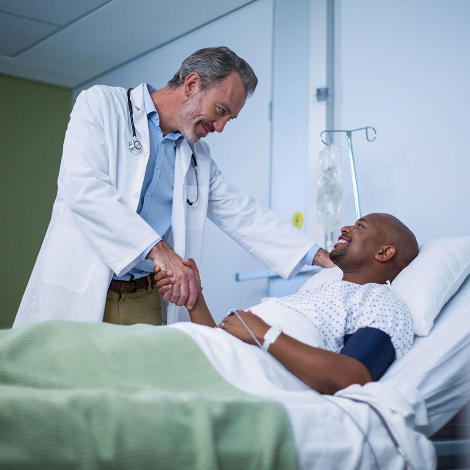 A doctor talks to a man in a hospital bed. The workers’ compensation lawyers at Horenstein, Nicholson & Blumenthal know how to prove medical professionals’ claims.